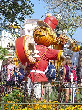 Parade at the Magical Kingdom - scarecrow and yellow fall flowers.