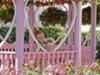 Minnie Mouse's garden has pink flowers and a pink gazebo