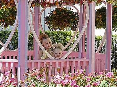 Minnie Mouse's garden has pink flowers and a pink gazebo